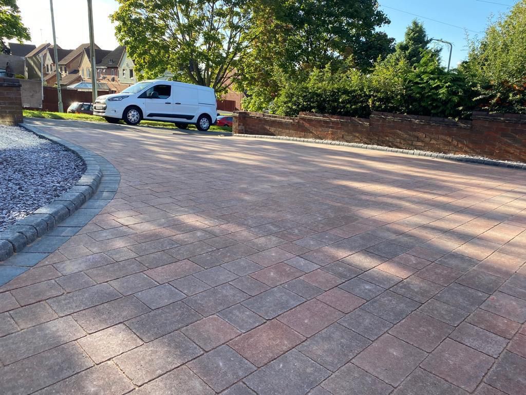 Sweeping block paved driveway with charcoal edging laid by Cresta Driveways