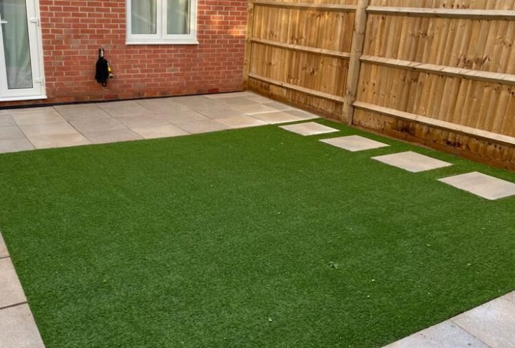 Paved patio with artificial lawn and stepping stones